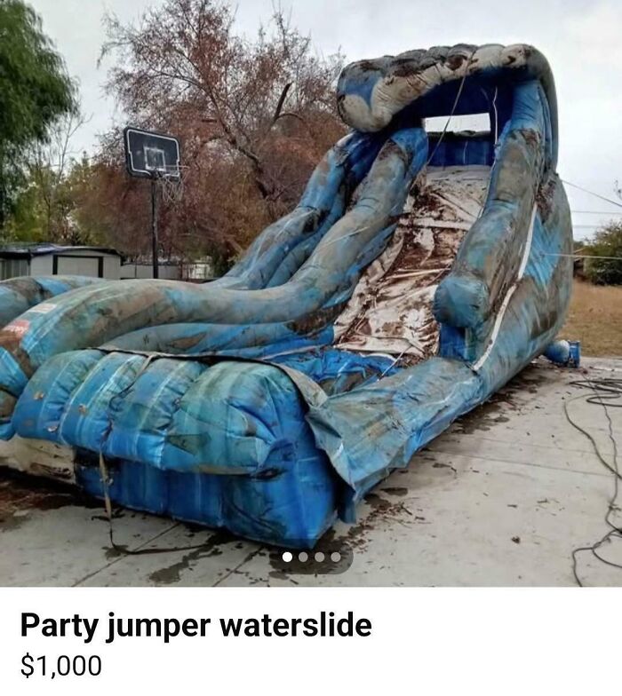 Worn inflatable waterslide for sale online, showing signs of wear and dirt, listed at $1,000.