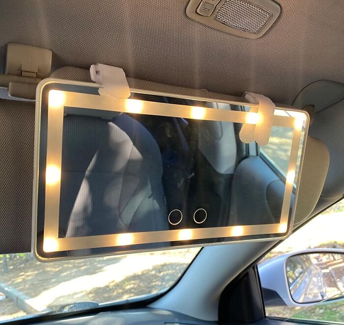 Car accessory: illuminated car visor mirror with LED lights, enhancing visibility.