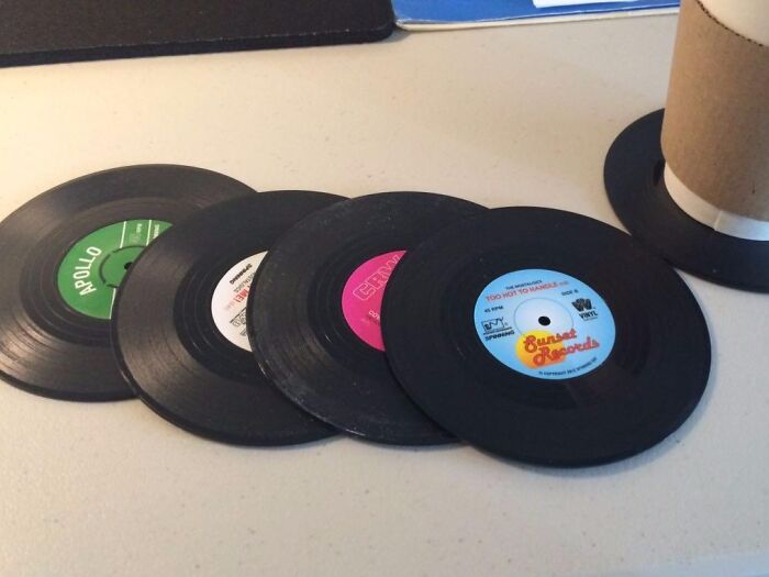 Vinyl records scattered on a table, capturing a nostalgic retro vibe with colorful labels.