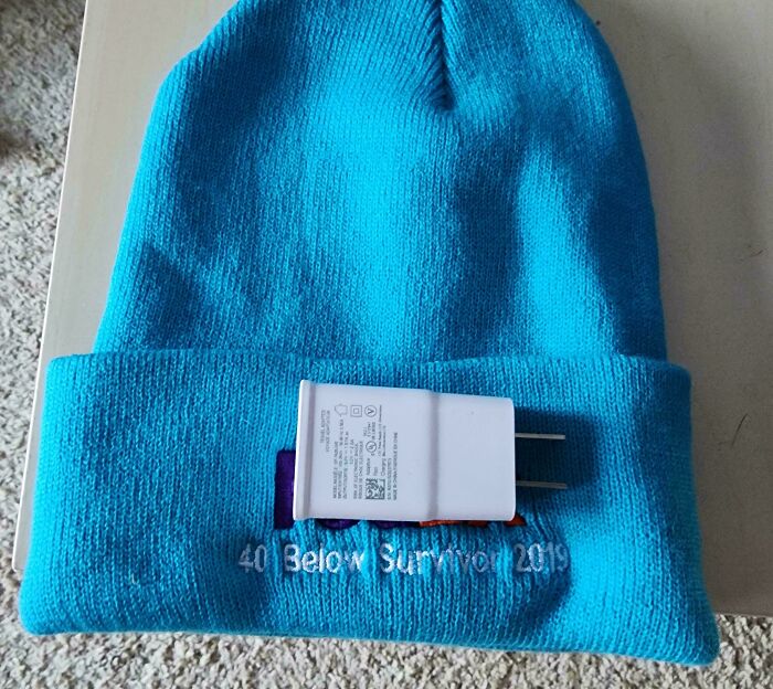 Blue beanie with "40 Below Summer 2019" text and a charger, representing infuriating company gifts.