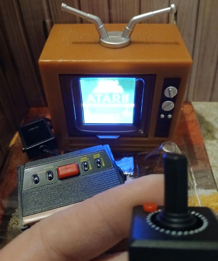 Retro Fever: Vintage Atari console with joystick in front of a small retro TV screen.