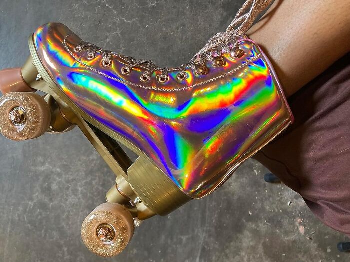 Holographic roller skate with a retro design on a textured surface, showcasing vibrant rainbow colors.