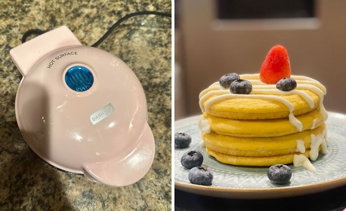 Mini waffle maker and a stack of four pancakes topped with blueberries and a strawberry.