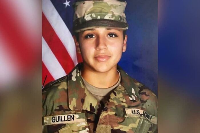 U.S. Army soldier in camouflage uniform with flag background, related to true crime stories and curiosities.