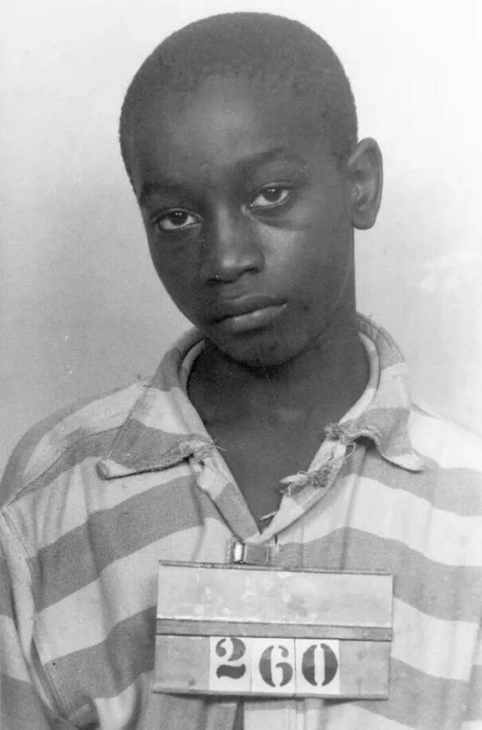 Young boy in striped prisoner uniform, part of chilling true crime stories collection.