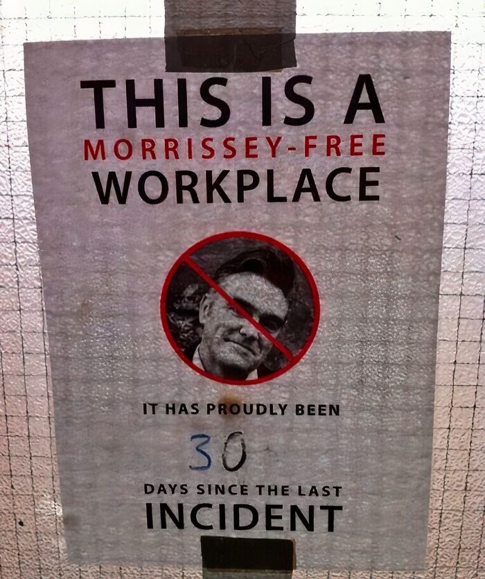 Sign reading "This is a Morrissey-free workplace" with a crossed-out image, 30 days since last incident; British humor evident.