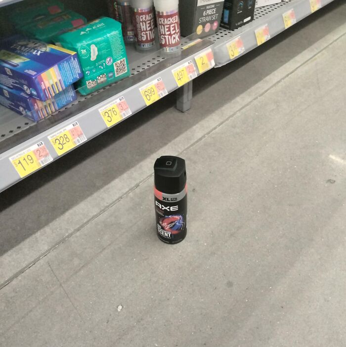 Deodorant can left on the store floor, blocking the aisle, exemplifying people being jerks.