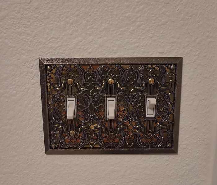 Decorative light switch cover with intricate design, representing renter-friendly upgrades.