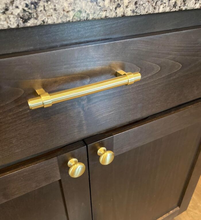 Gold handles on dark wood cabinets, representing renter friendly upgrades.