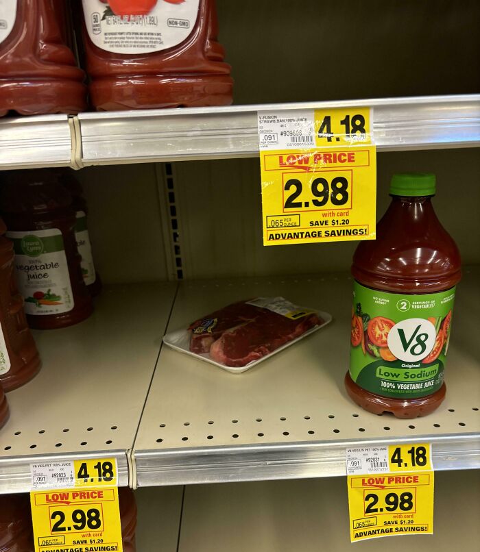 Grocery store shelf with misplaced meat among juice bottles, highlighting people being jerks.