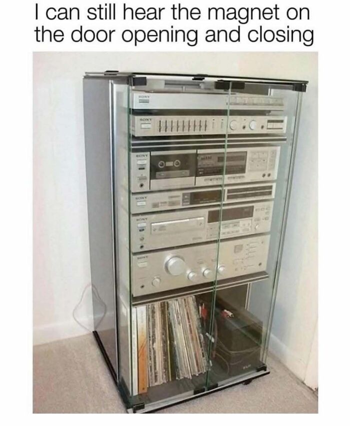 Old stereo system in a glass cabinet, bringing nostalgic memories with vintage audio equipment and records.