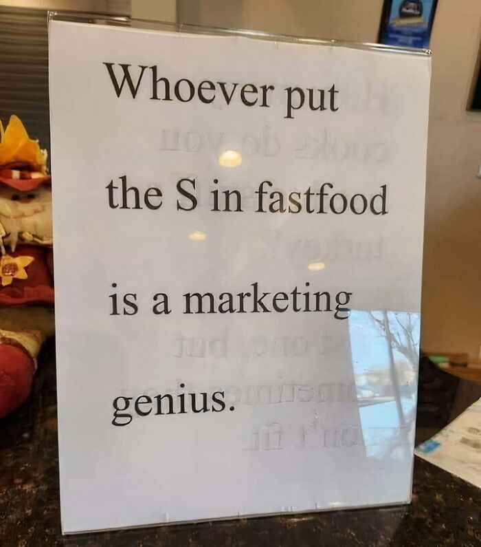 Sign with a linguistic meme joke about fast food marketing inside a restaurant setting.