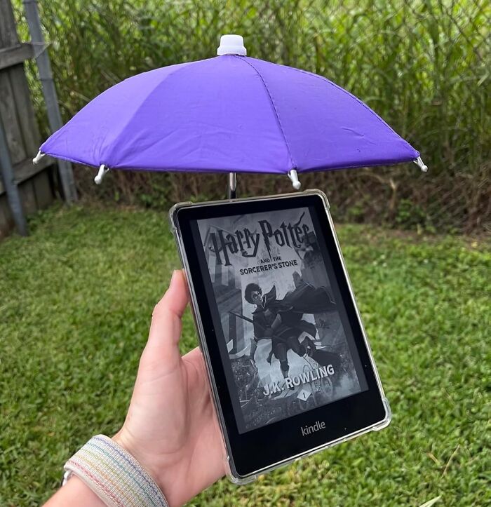 A Kindle with a mini purple umbrella attached, showcasing a weird gift idea for that hard-to-shop-for friend.