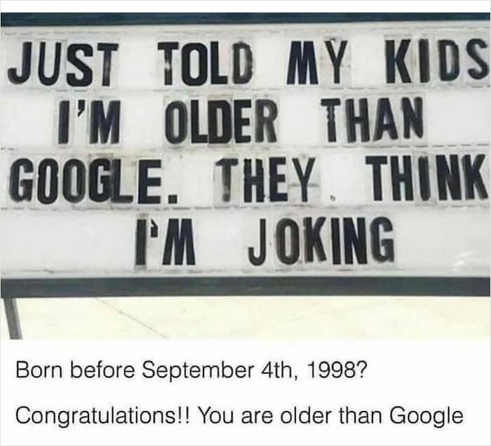 Sign reads "I'm older than Google," humorously capturing nostalgic memes theme.