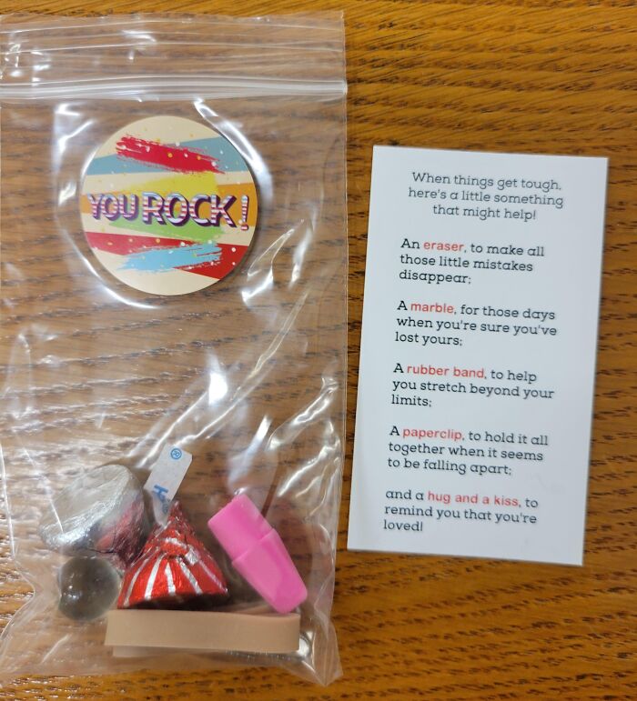 Company gifts include a motivational note, paperclip, eraser, marble, and candy in a plastic bag.