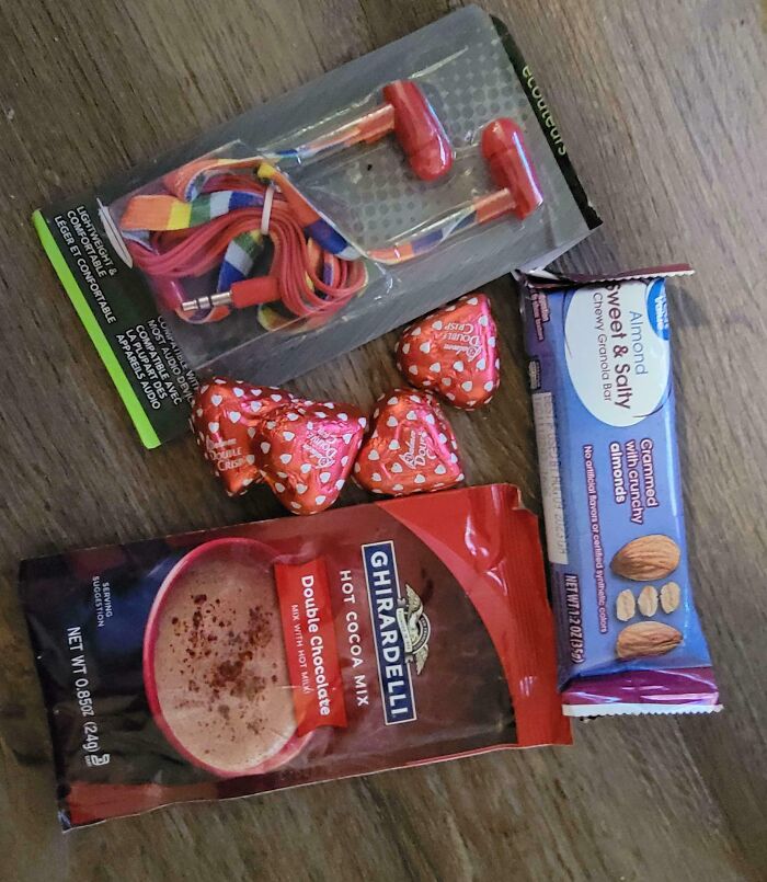 Colorful earbuds, a sweet and salty granola bar, chocolates, and hot cocoa mix—an infuriating company gift.