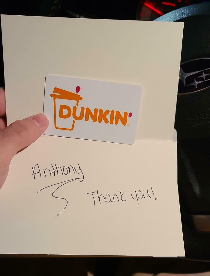 A Dunkin' gift card inside a thank you note, representing company gifts and bonuses.