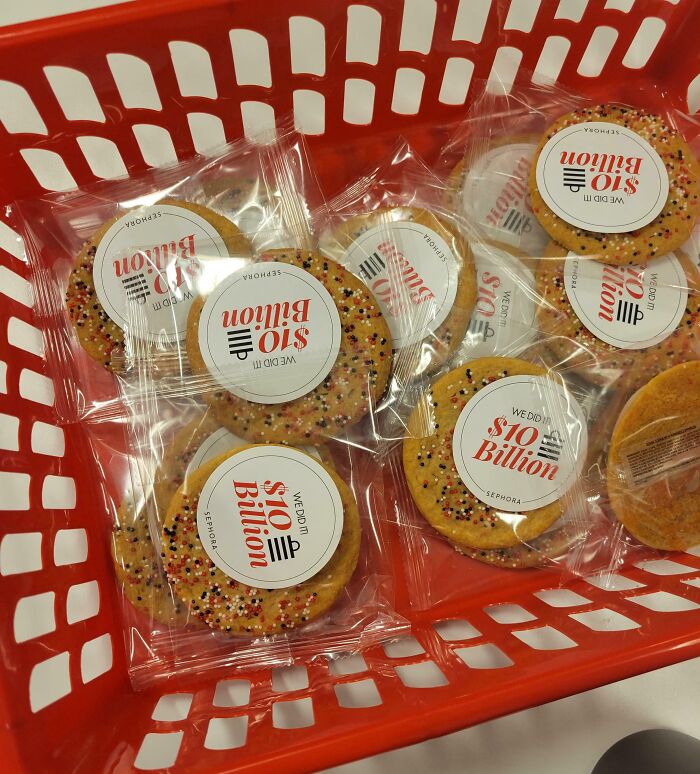 Basket of cookies in clear wrapping with labels celebrating a $10 billion milestone, representing company gifts.