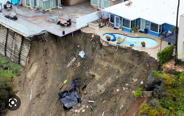 Landslide under a patio and pool, showing expensive damage to property.