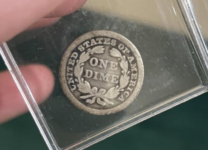 Vintage coin labeled "One Dime," cherished by numismatists.