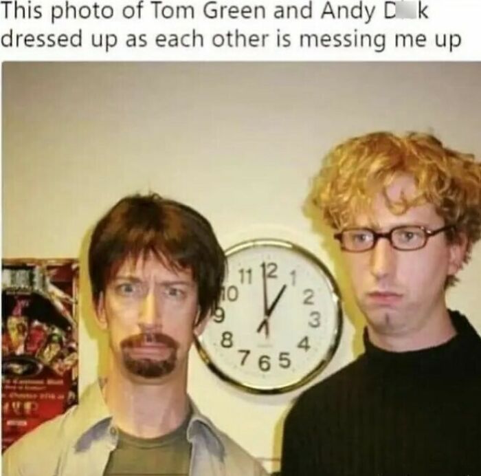 Two men with swapped hairstyles and outfits posing in front of a wall clock; showcasing bizarre humor from an eclectic Instagram page.