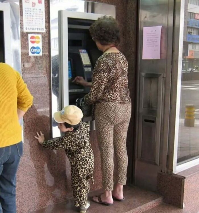 A person and a child in leopard-print outfits using an ATM, capturing bizarre fashion from an eclectic Instagram page.