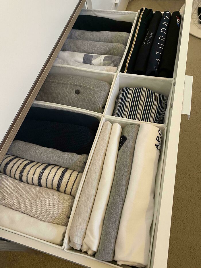 Neatly organized clothes in a drawer with dividers, showcasing next-level organization.