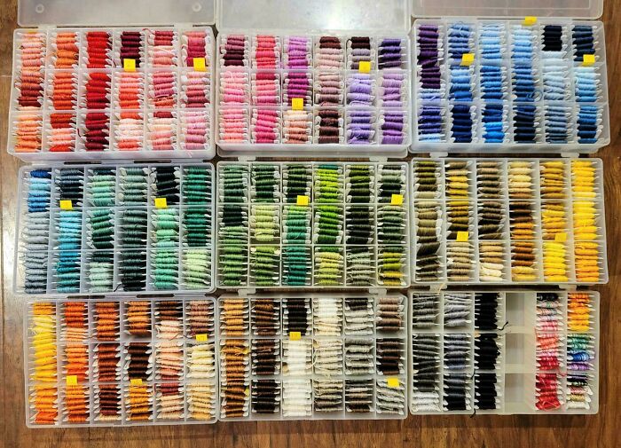 Next-level organization of colorful threads neatly arranged in transparent boxes.