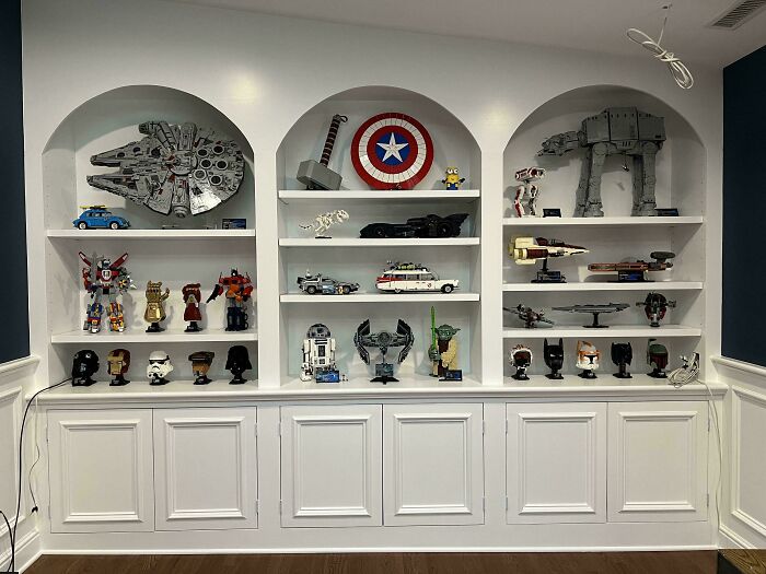 Next-level organization displayed on neat shelves with collectibles, including superhero and sci-fi models, neatly arranged.