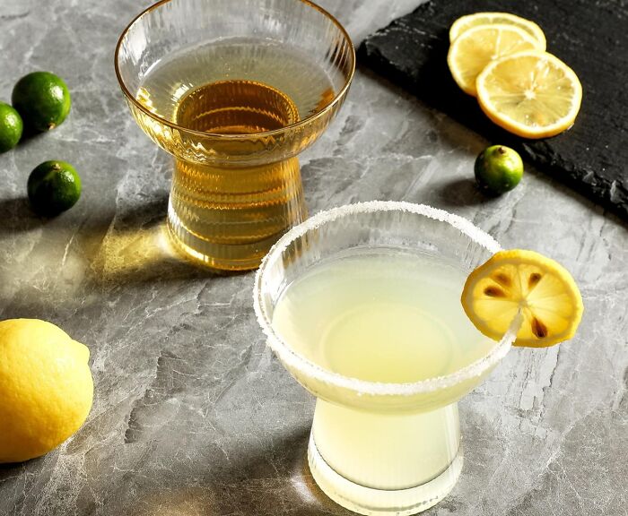 Stylish cocktail glasses with drinks and lemon, perfect for a showoff.