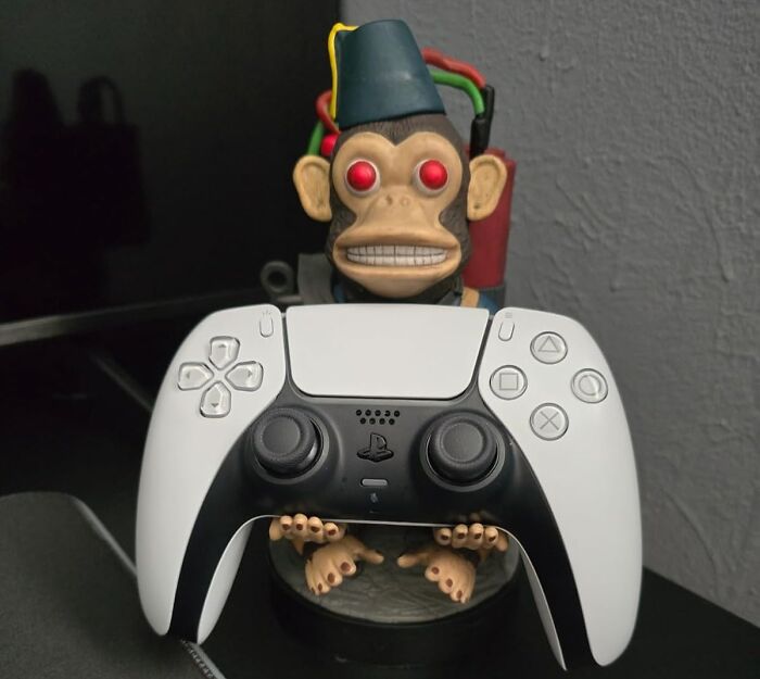 "Cool product: gaming controller with a playful monkey figure in the background, showing off unique design."