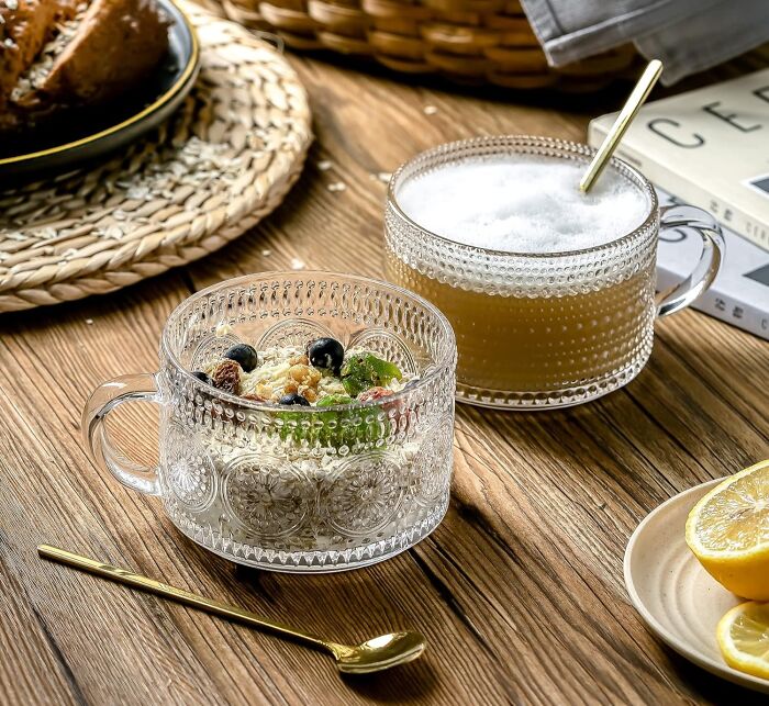 Elegant glass mugs with granola and a foamy drink on a rustic table, ideal for best Valentine's Day finds.