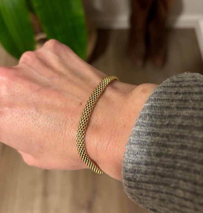 Gold bracelet on wrist, perfect Valentine's Day gift idea.