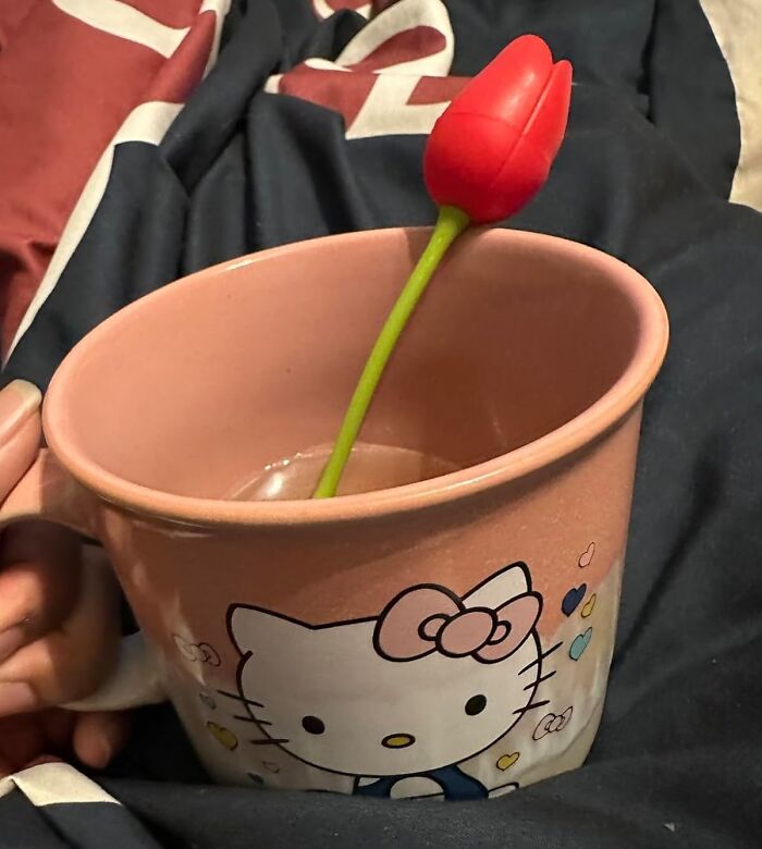 Pink Hello Kitty mug with a red tulip, a charming Valentine's Day find.