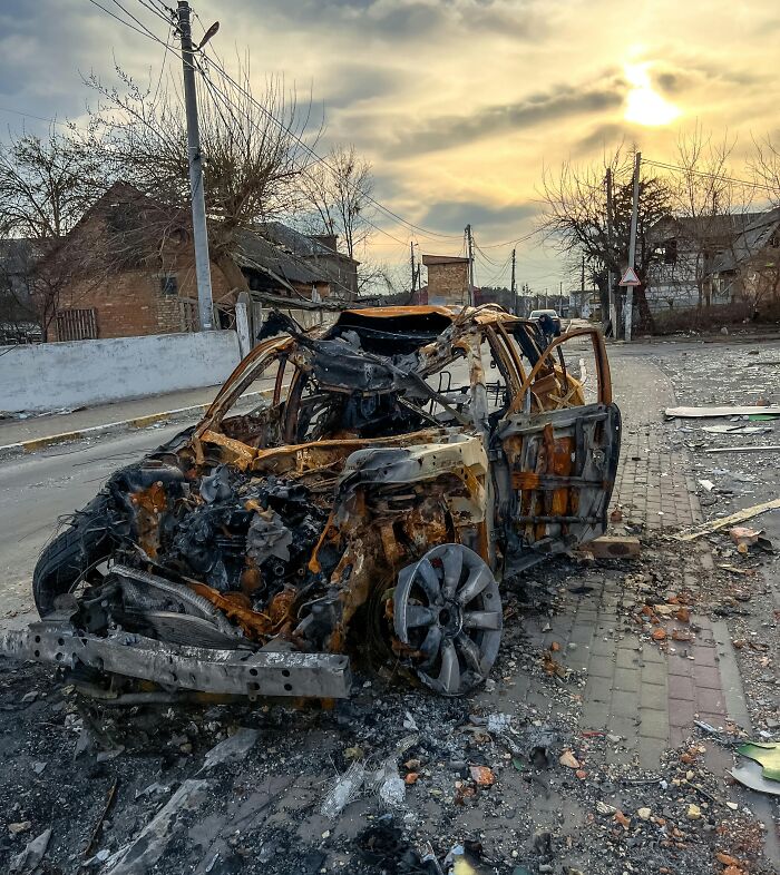 Burned car on a street at sunset, illustrating a dramatic true crime case plot twist.