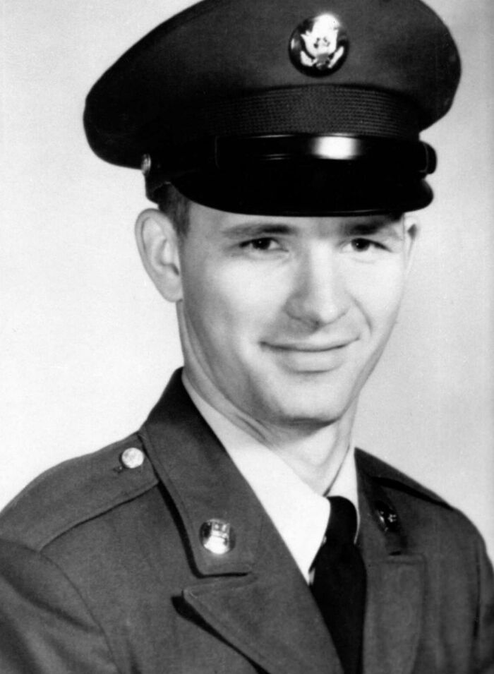 Young soldier in uniform, smiling, related to true crime cases plot twists.