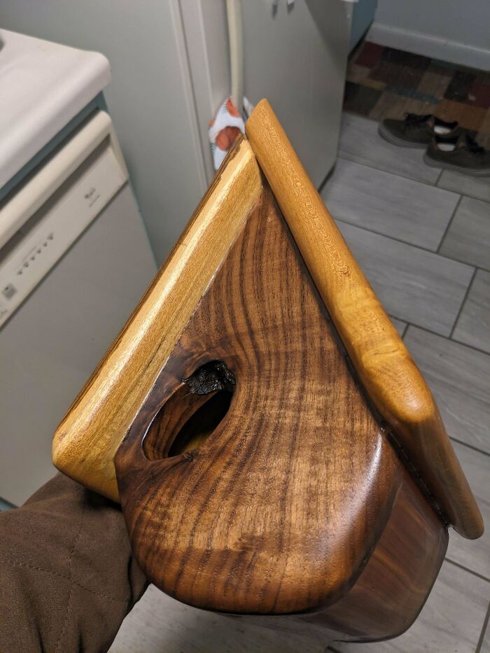 Handcrafted wooden birdhouse showcasing impressive woodworking skills and attention to detail.