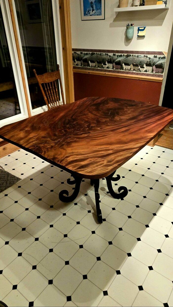 Beautifully crafted wooden table with intricate design, showcasing an impressive woodworking project in a cozy room setting.