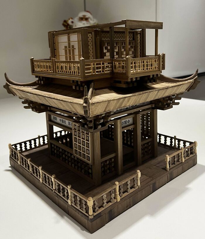 Intricate woodworking project of a detailed wooden structure with ornate design elements.