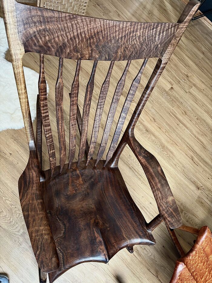 Handcrafted wooden chair with intricate design, showcasing impressive woodworking craftsmanship and attention to detail.