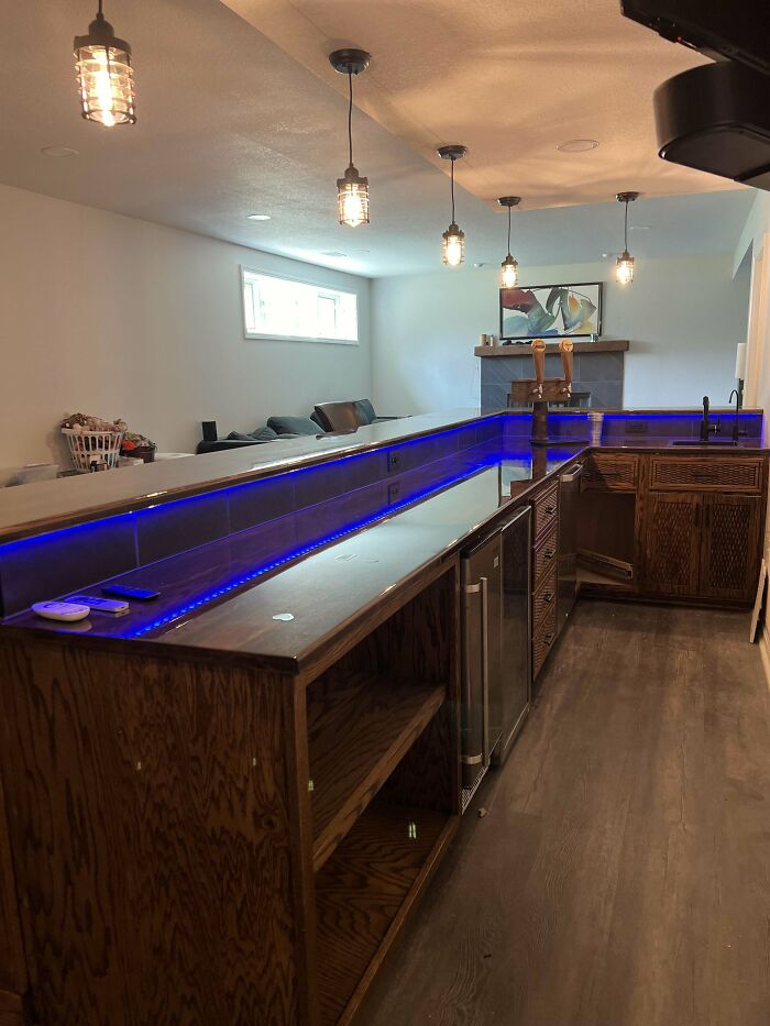 Woodworking project showcasing a modern bar with custom wood cabinets and blue LED lighting.