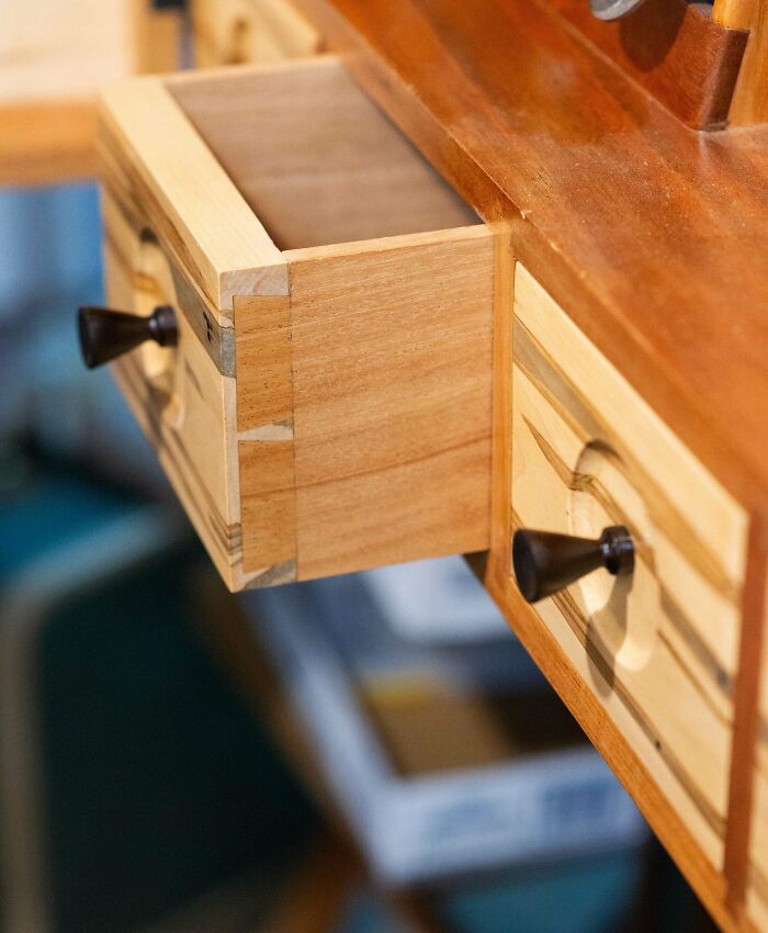 A beautifully crafted wooden drawer showcases impressive woodworking skills.