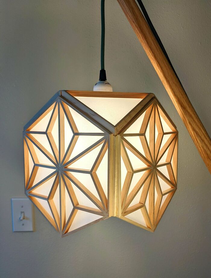 Geometric wooden lamp with intricate design, showcasing an impressive woodworking project.