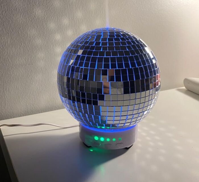 Disco ball-shaped office supply glowing in blue on a desk, adding fun to the workspace.