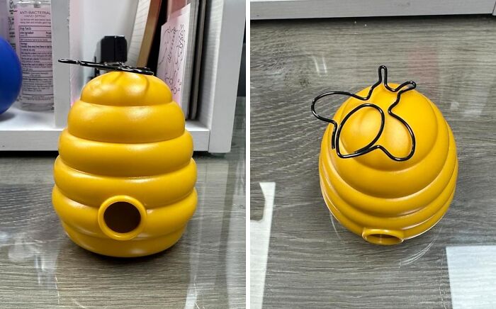 Yellow beehive-shaped office supply holder proving work can be fun, with a black bee clip on top.