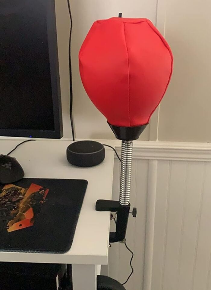 Desk with a red punching bag office supply, adding fun to the workspace.