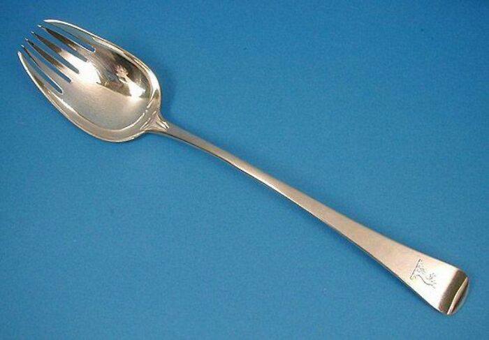 Silver spork on a blue background, representing historical inventions ahead of their time.