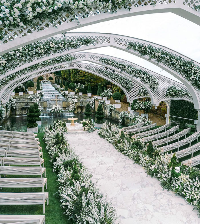 Luxurious wedding venue with arches adorned in flowers, reflecting a viral wedding theme.