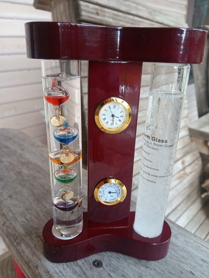 Innovative home gadget with a Galileo thermometer and storm glass on a wooden base.