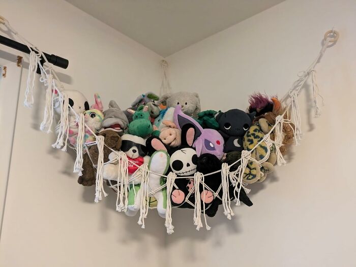 Stuffed animals in a macrame hammock bringing joy into your home.